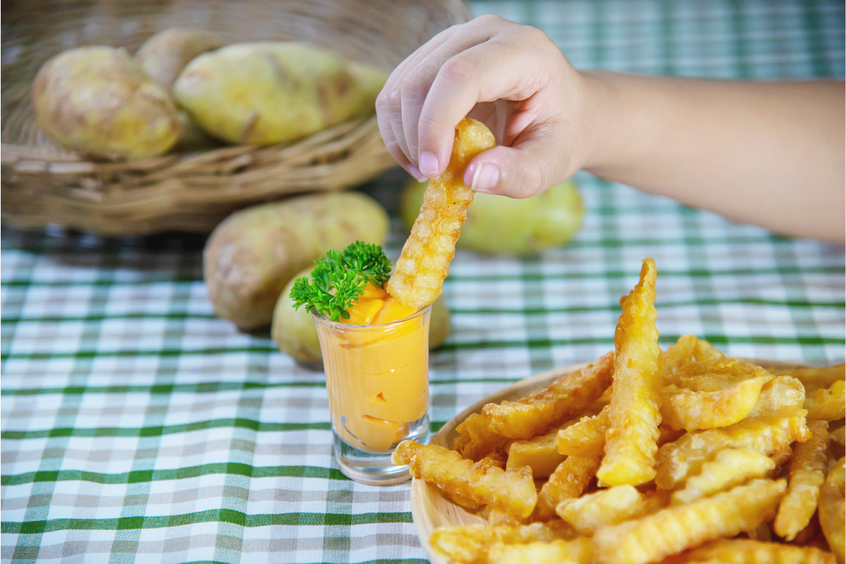 Creative serving suggestion for crinkle fries, showing a fry tower garnished with parmesan and fresh herbs.