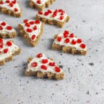 Close-up of a Good Humor strawberry shortcake bar showing its creamy strawberry center and crumbly cake coating