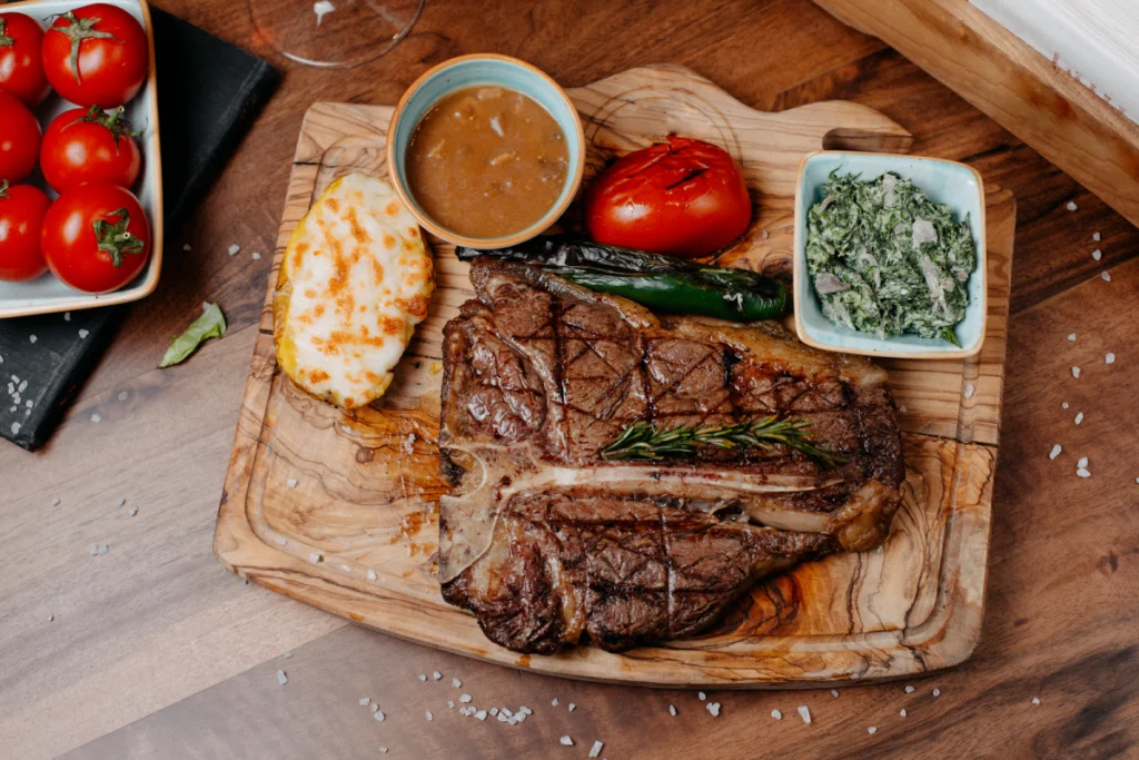 Raw beef bottom round steak on a cutting board, ready for preparation.